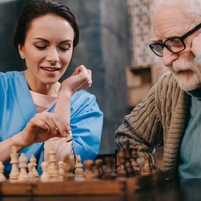 Nurse and senior man passionate about chess